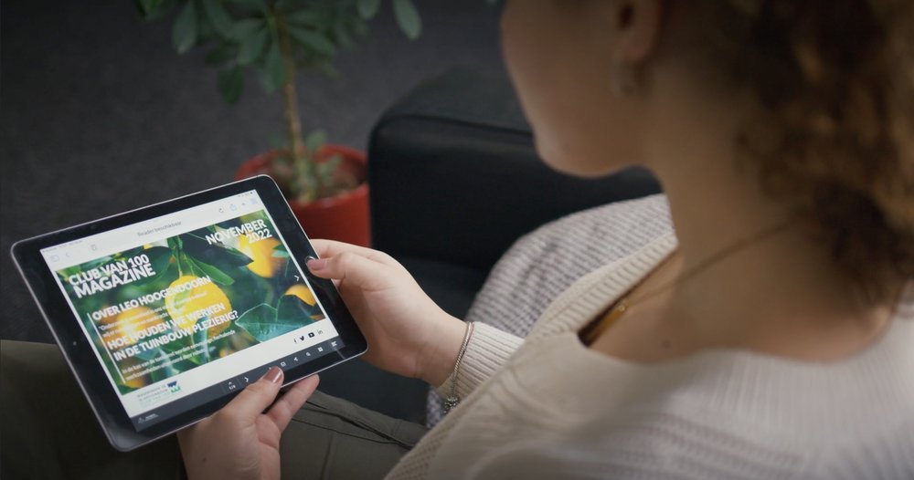 Girl holding tablet looking at digital magazine