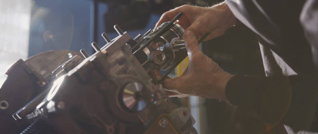 Man placing piston in place