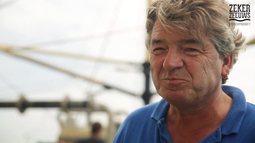 Man looking at camera with ship in background