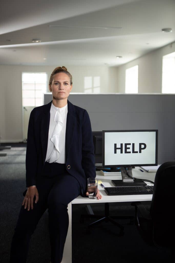 Woman sitting in office next to monitor