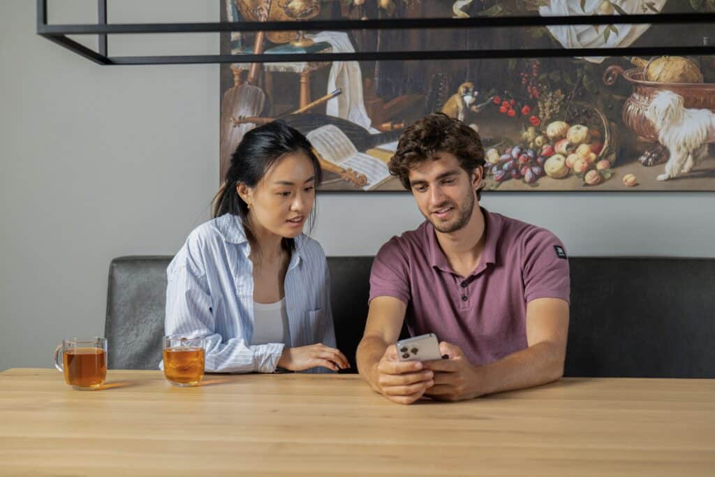 couple looking at phone at the dinner table