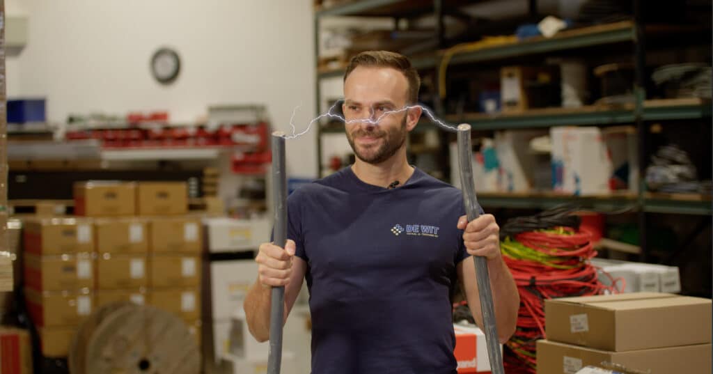 Man holding metal rods with electricity between them