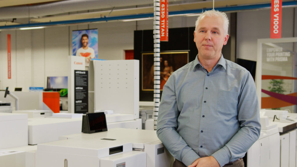 SSD employee standing next to Canon printer