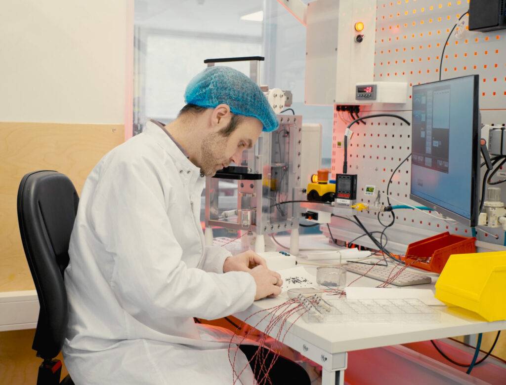 Man in lab coat working on computer