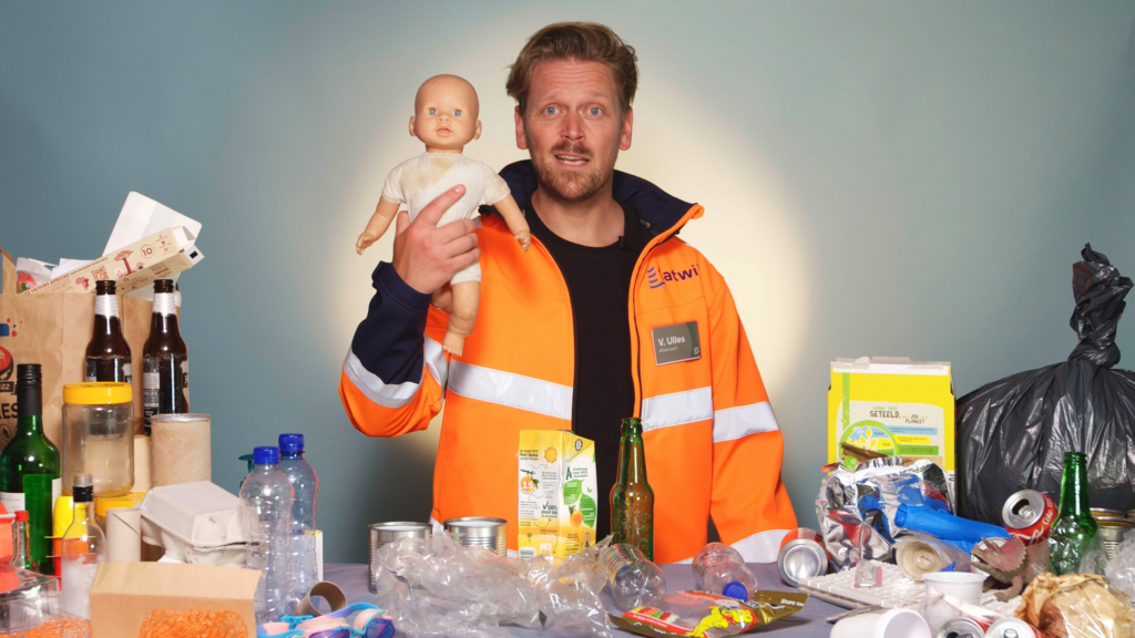 Man surrounded by trash holding a old baby doll